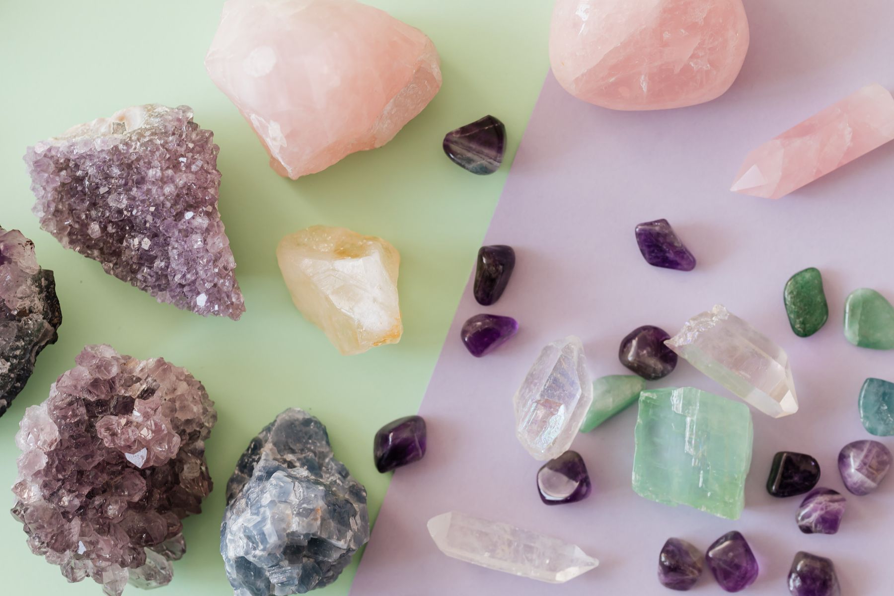 Amethyst, rose quartz and healing crystals arranged on soft pastel paper