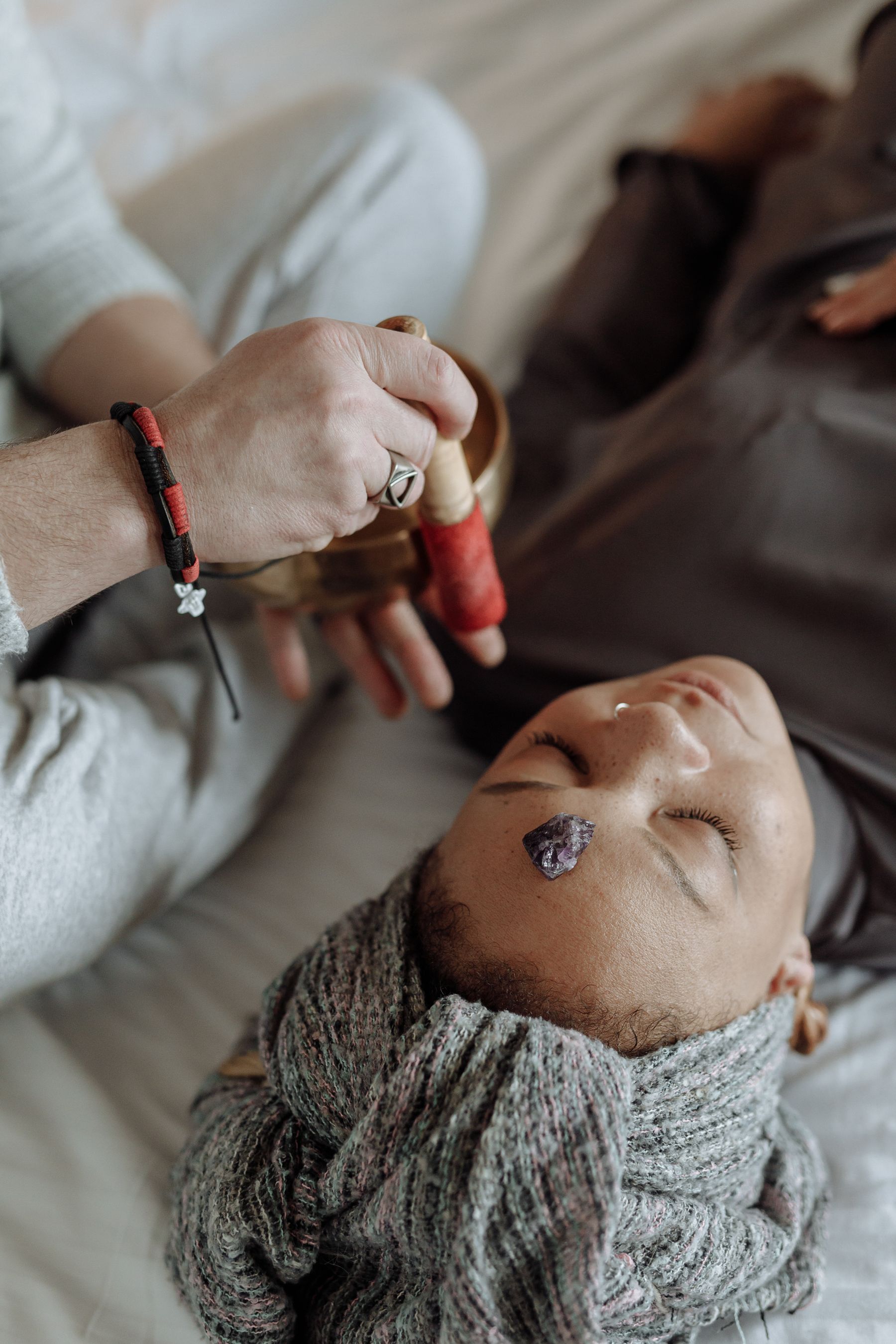 A sound bowl held gently during a calming energy session